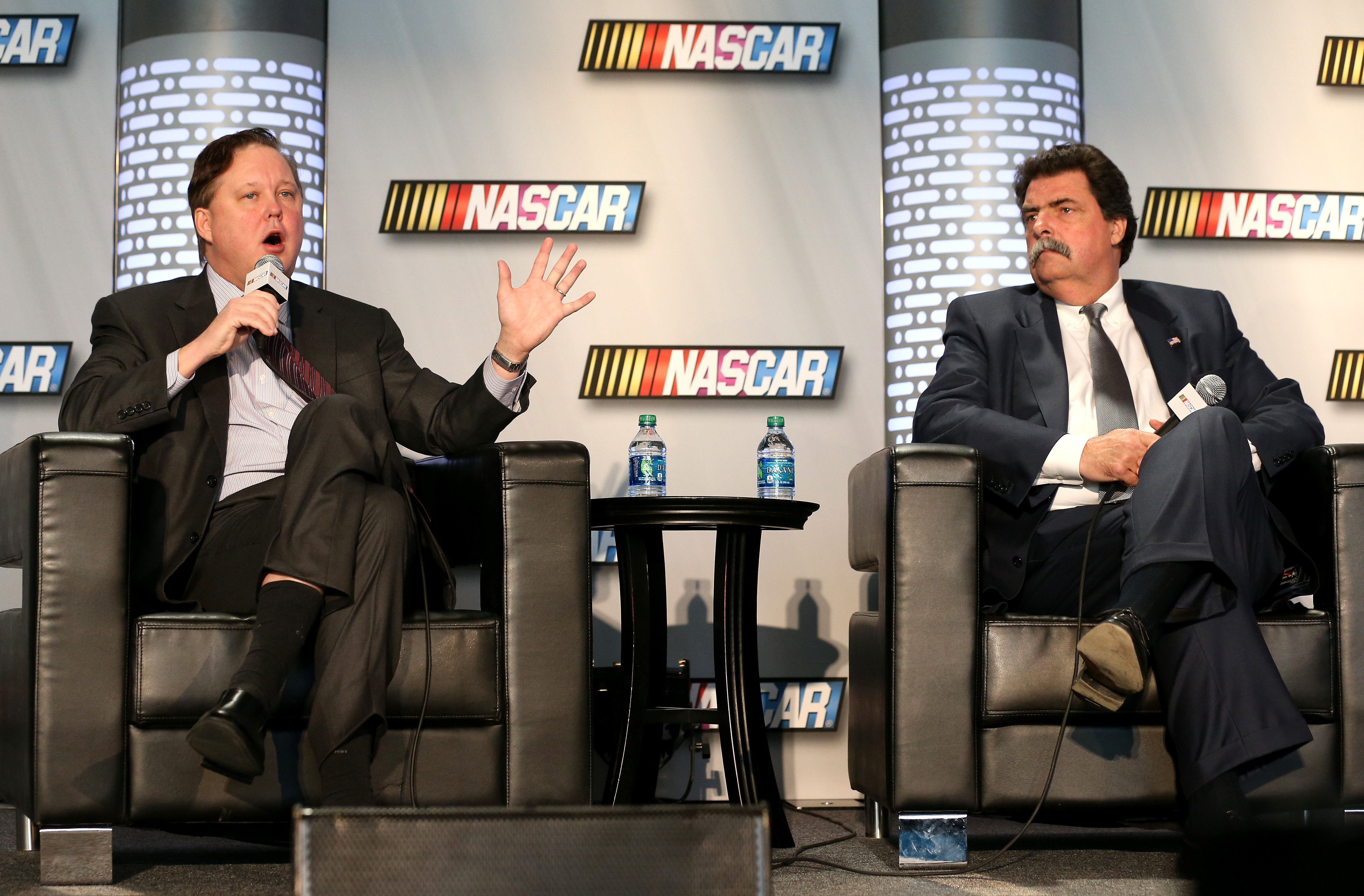 CONCORD, NC - JANUARY 22: (L-R) Brian France, NASCAR Chairman and CEO, and Mike Helton, President of NASCAR, speak to the media about the upcoming season during the 2013 NASCAR Sprint Media Tour at the NASCAR Hall of Fame on January 22, 2013 in Concord, North Carolina. (Photo by Streeter Lecka/Getty Images for NASCAR) | Getty Images
