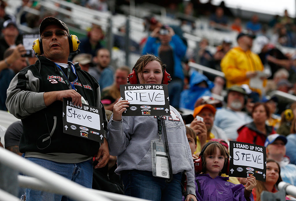 BRISTOL, TN - APRIL 19: Fans hold Stand Up 2 Cancer signs supporting Steve Byrnes during the NASCAR Sprint Cup Series Food City 500 at Bristol Motor Speedway on April 19, 2015 in Bristol, Tennessee. (Photo by Jeff Zelevansky/Getty Images) | Getty Images