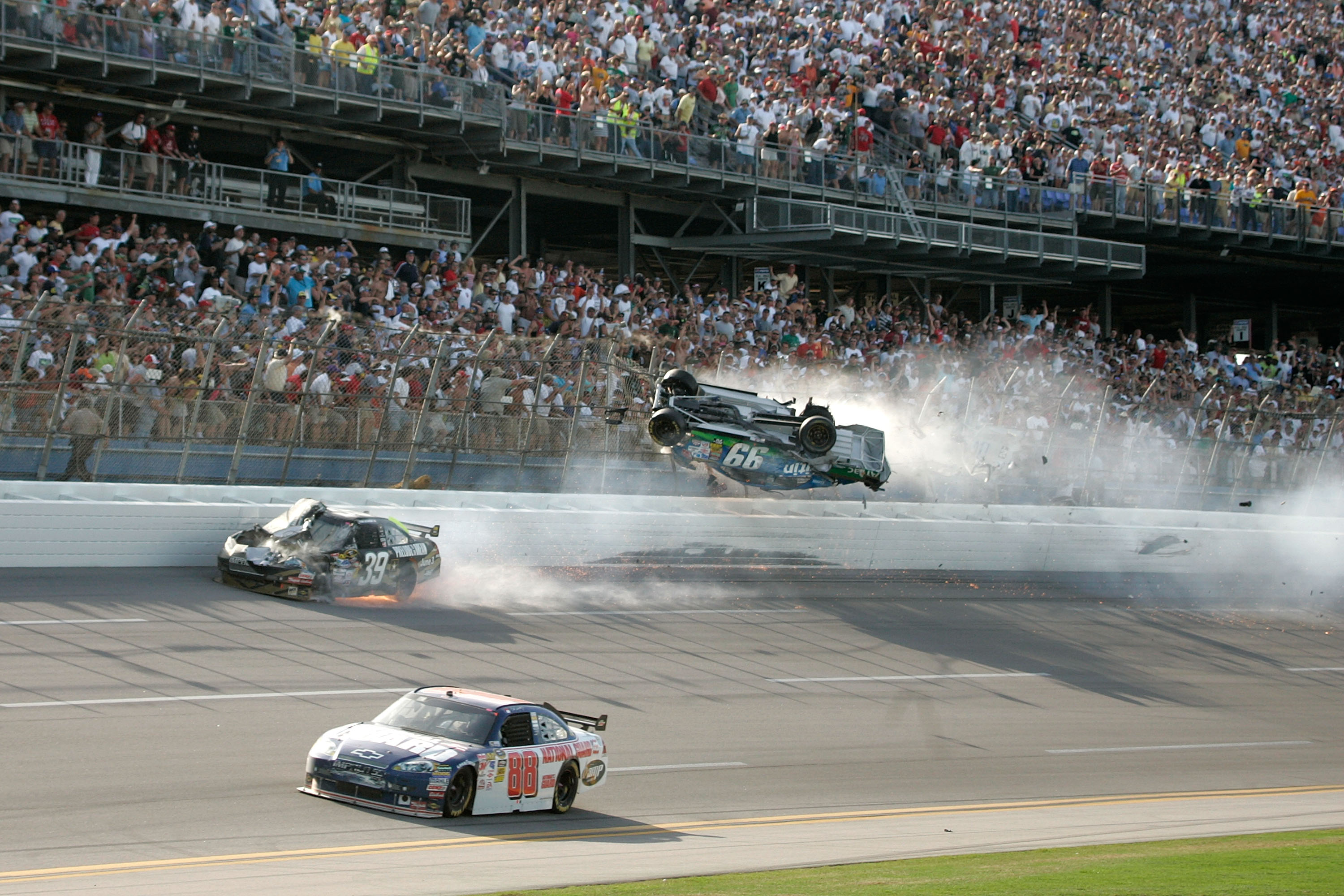 TALLADEGA, AL - APRIL 26: Carl Edwards, driver of the #99 Claritin Ford, goes airborne as Ryan Newman, driver of the #39 Steweart-Haas Racing Chevrolet suffers damage and Dale Earnhardt Jr., driver of the #88 National Guard / AMP Energy Chevrolet drives at the conclusion of the NASCAR Sprint Cup Series Aaron