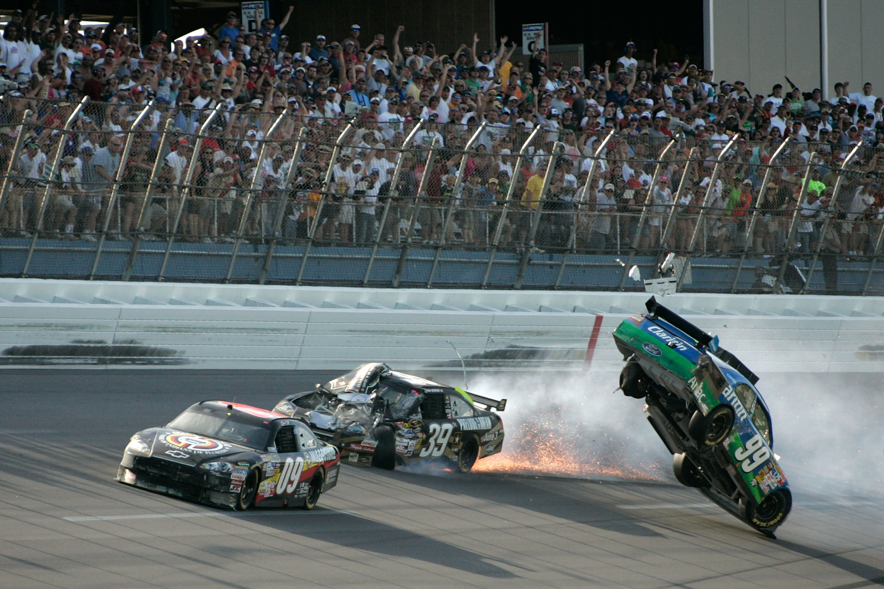 TALLADEGA, AL - APRIL 26: Carl Edwards, driver of the #99 Claritin Ford, goes airborne as Ryan Newman, driver of the #39 Steweart-Haas Racing Chevrolet suffers damage and Brad Keselowski, driver of the #09 Miccosukee Indian Gaming Chevrolet drives at the conclusion of the NASCAR Sprint Cup Series Aaron