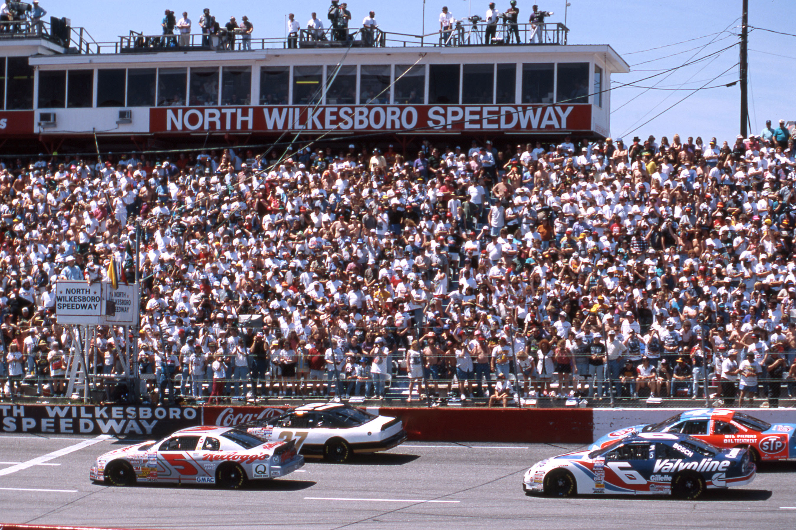 NORTH WILKESBORO, NC - APRIL 14, 1996: Terry Labonte (No 5) and Elton Sawyer (No 27) bring the field to the start of the First Union 400 at North Wilkesboro Speedway. Mark Martin is in No. 6 and the No. 43 is Bobby Hamilton. (Photo by ISC Images & Archives via Getty Images)