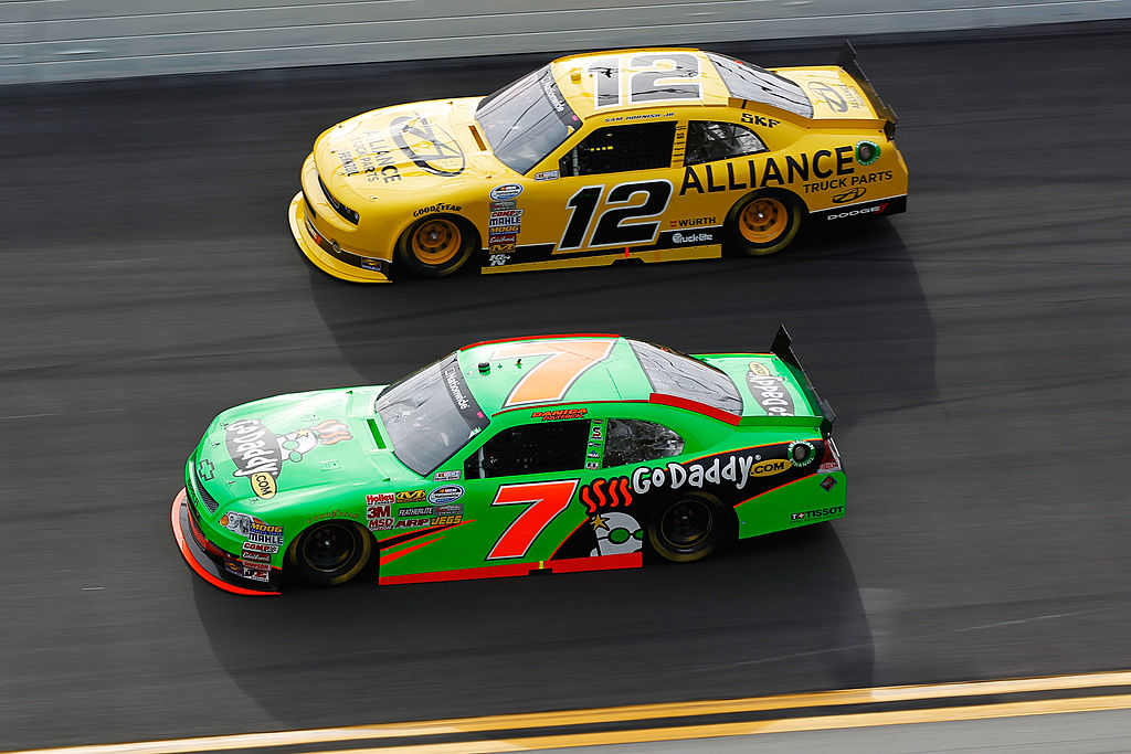 DAYTONA BEACH, FL - FEBRUARY 25: Danica Patrick, driver of the #7 GoDaddy.com Chevrolet, and Sam Hornish Jr., driver of the #12 Alliance Truck Parts Dodge, race during the NASCAR Nationwide Series DRIVE4COPD 300 at Daytona International Speedway on February 25, 2012 in Daytona Beach, Florida. (Photo by Streeter Lecka/Getty Images) | Getty Images